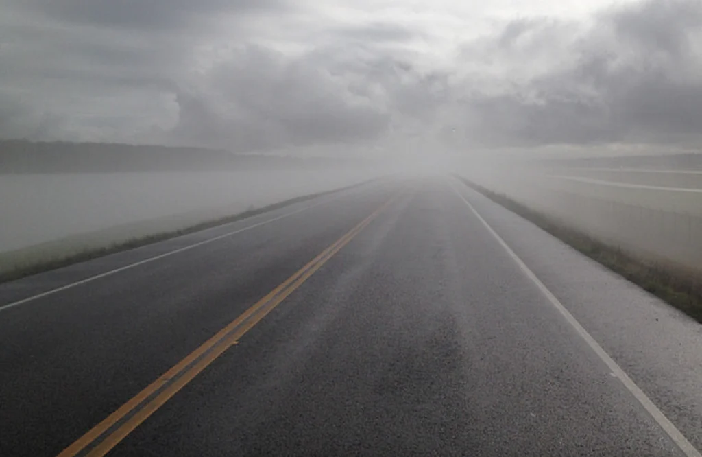 Gray highway under gray sky